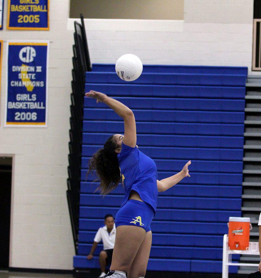 No. 4 Lauren Vaca serves the ball. 