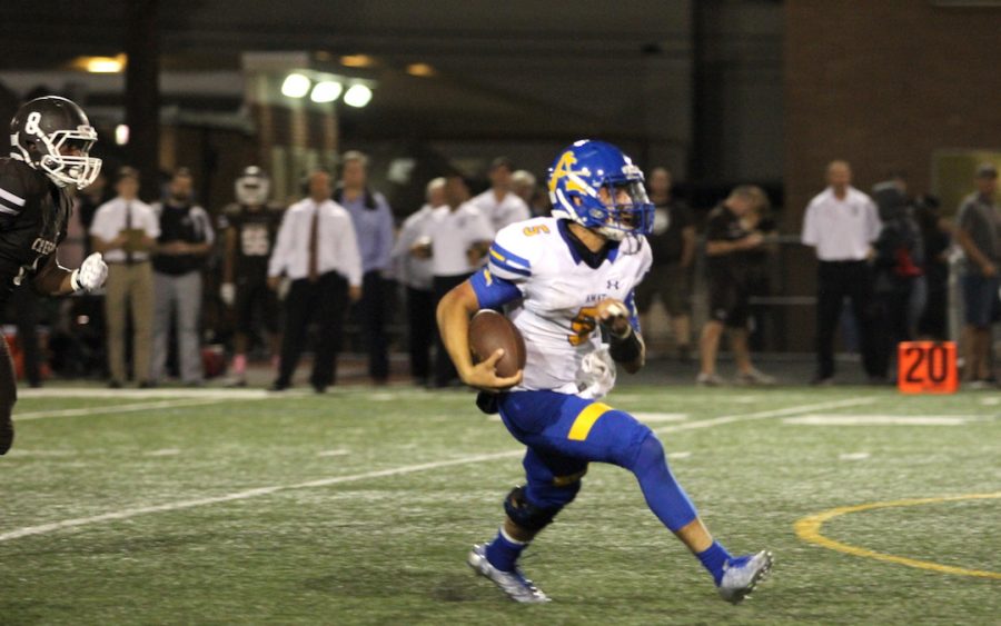 Quarterback Jake Amaro runs away from the Crespi defense.