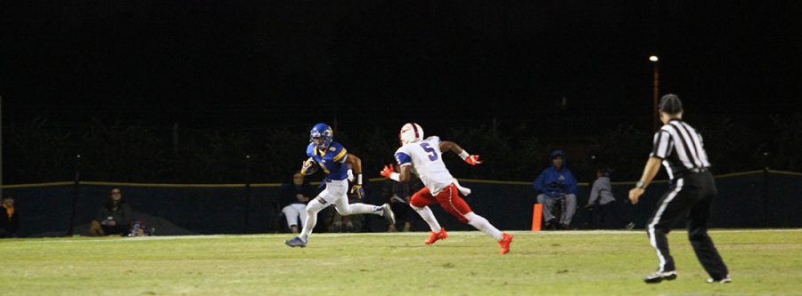 Noah Guzman sprinting pass an opponent.