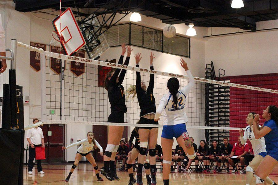 Amat hits the ball over Arcadia's block.