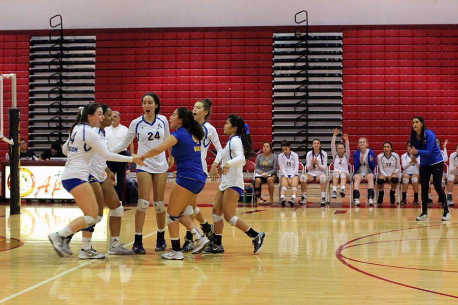 Varsity volleyball celebrating their point.