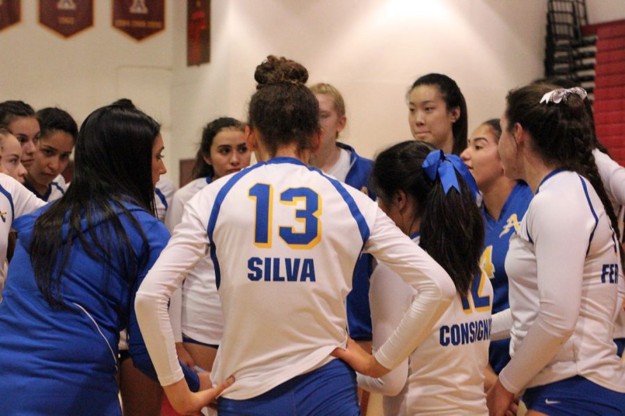 Team meets during a time out to talk about the game plan.