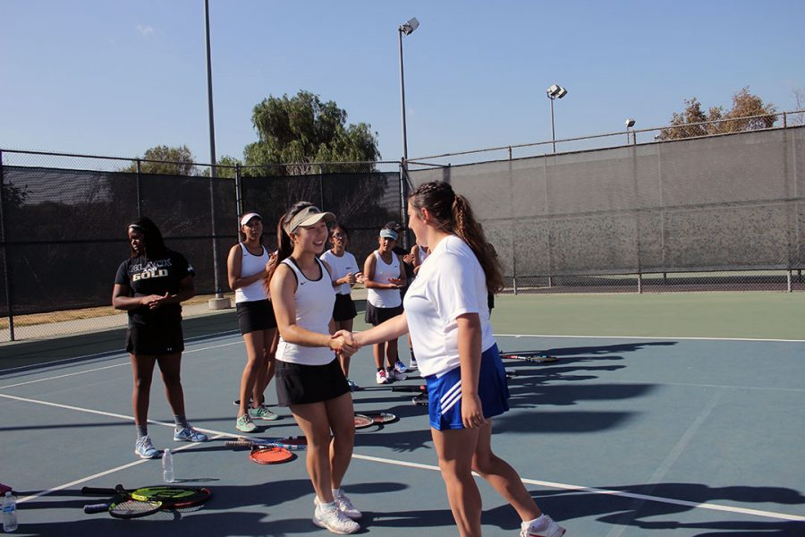 No.3 singles Carina Giancanelli meets her opponent.