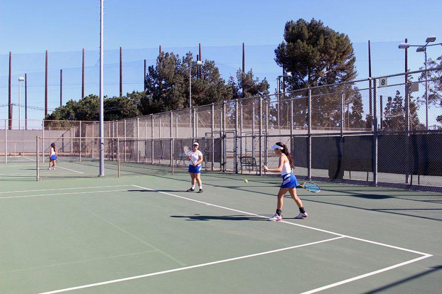 Doubles partners Iliana Herrera and Diana Rodriguez warming up.
