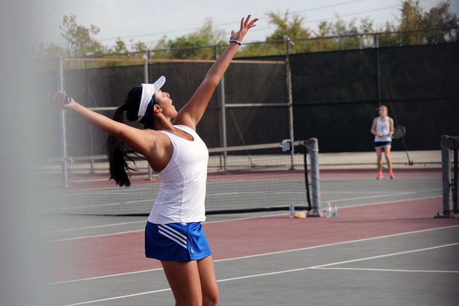 Kalea Fajardo tosses the ball to serve.