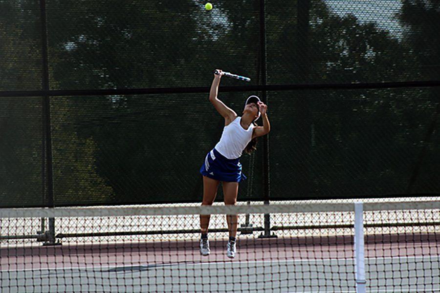 Jade Go serves the ball.