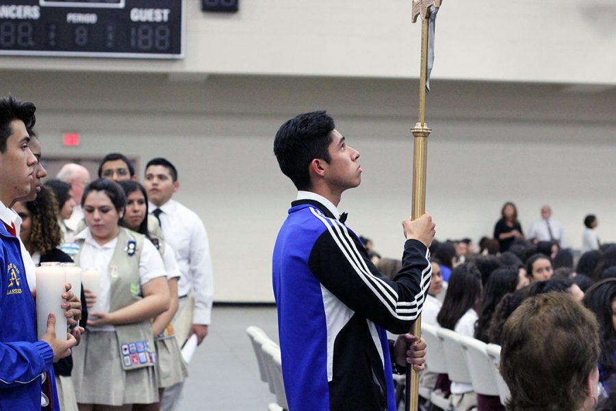 Diego Payan holding the cross. 