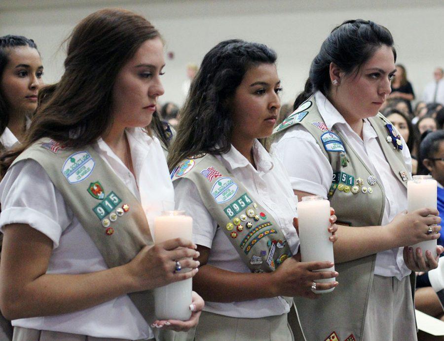 Girl Scouts walking down the aisle. 