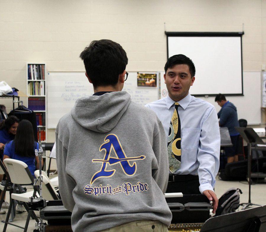 Mr. Banas speaks to a percussion member. 