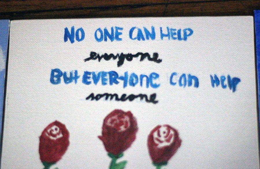 No one can help everyone, but everyone can help someone. Students paint motivational messages.