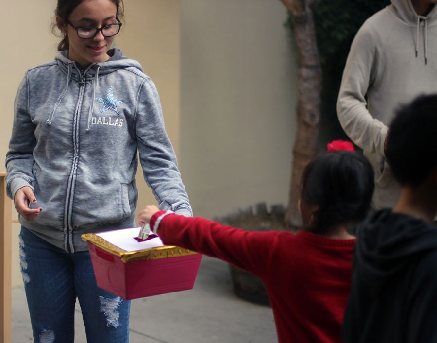 A young girl gives money to the famine.