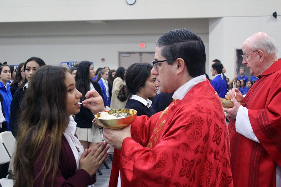 A student receives the Eucharist.