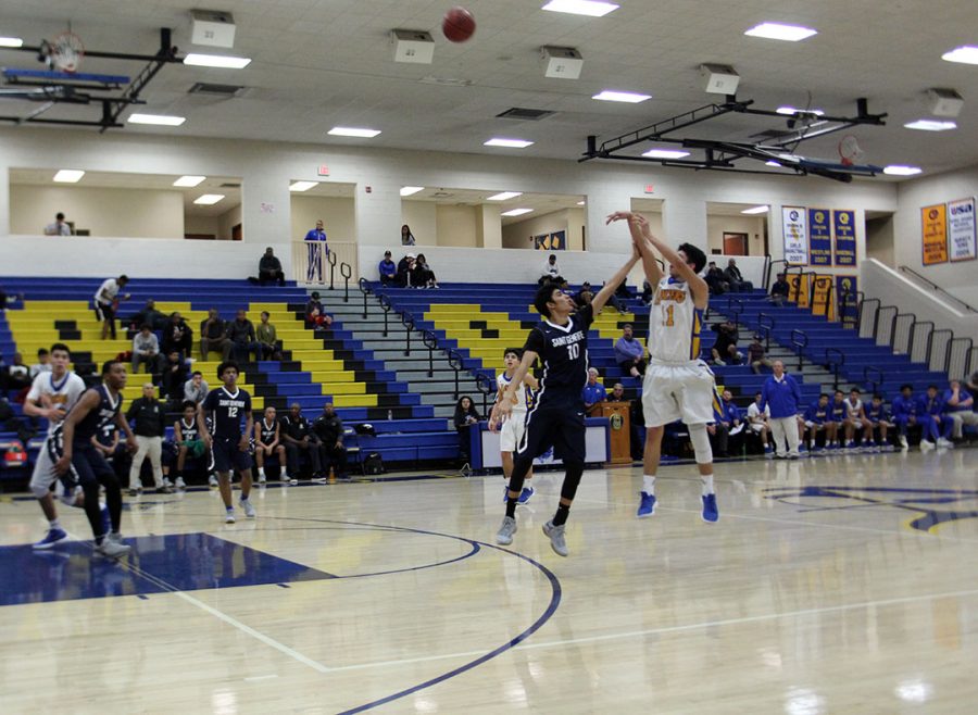 Jonathan Aguirre shoots the ball from behind the top of the key.