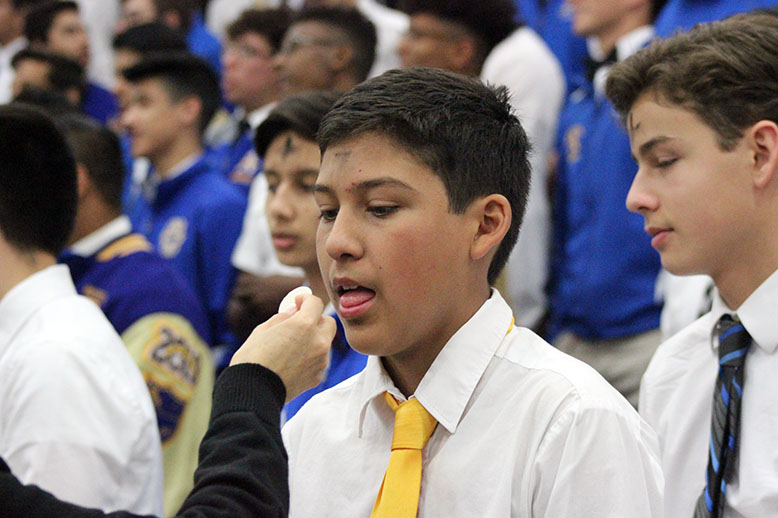 A student receiving the Eucharist. 