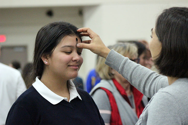 A student receiving ashes. 