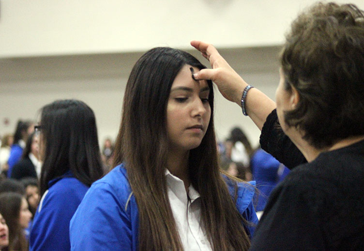 A student receiving ashes. 