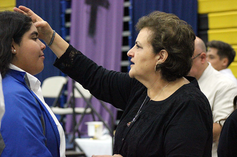 Ms. Fortner giving ashes to students. 