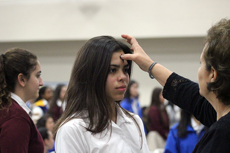 A student receiving ashes. 