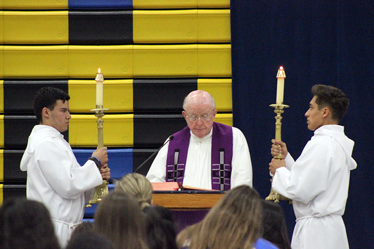 Monsignor reading the Gospel. 