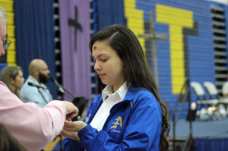 A student receiving the Eucharist. 