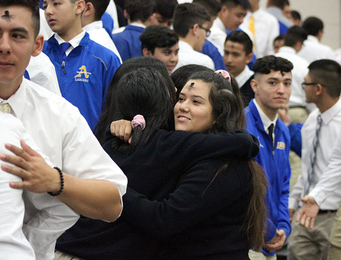 Vicki Gurol and Justine Leiva exchanging the sign of peace.