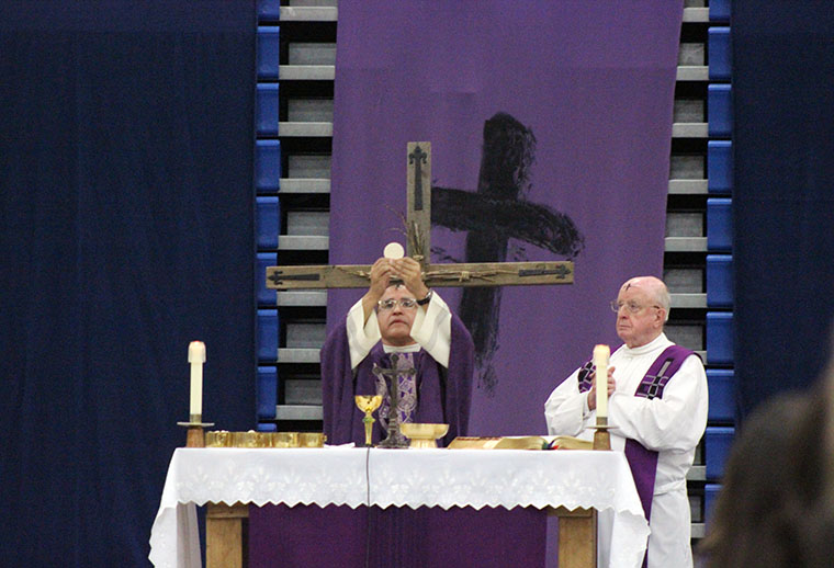 Father witnessing the bread's transformation into the Body of Christ. 