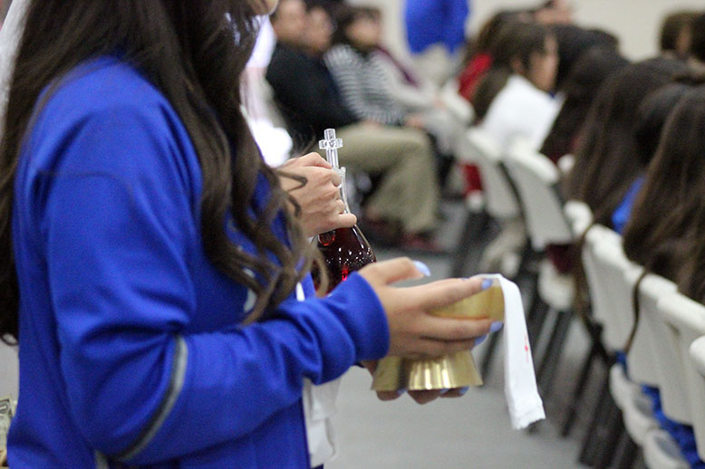 The bread and wine being presented to the alter. 