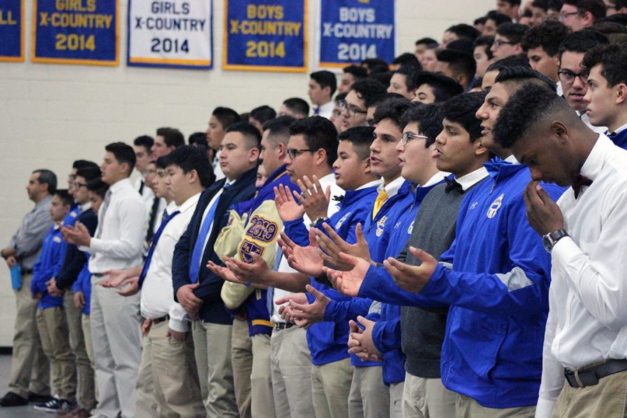 Students open their hands to accept the blessing.