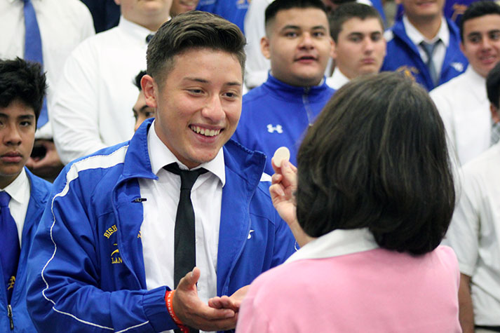 A+student+receives+the+Eucharist.