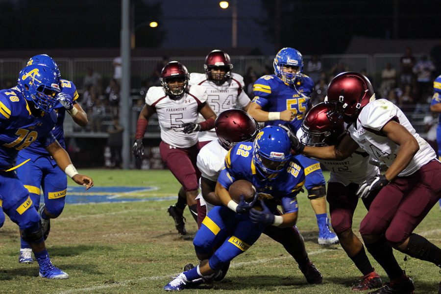 Chris Lopez gets tackled by Paramount player.