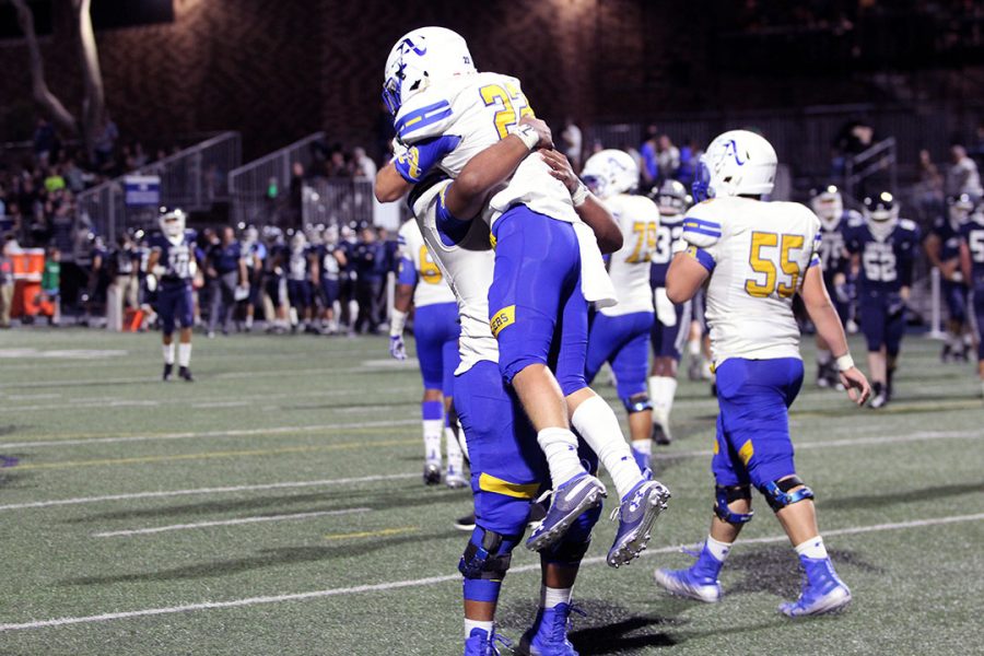 Amat Football Lancers celebrate after scoring a touchdown.