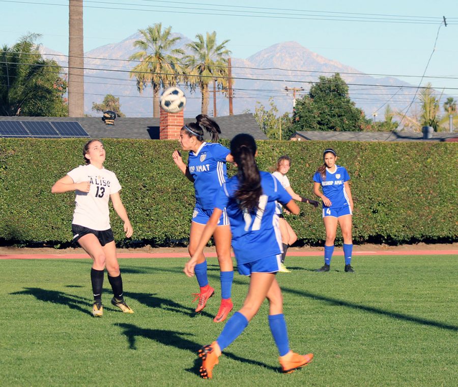 Varsity player headbutts Aliso Niguels return kick.