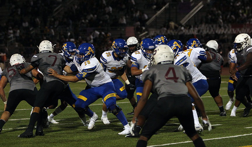 Jacob Ramirez and Zeke Cisneros lead the block for Dyson McCutcheon. 