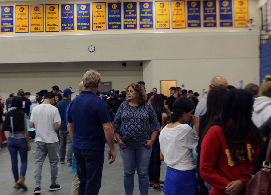 Crowds of parents and students viewing different colleges. 