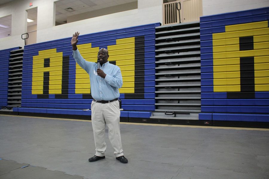 Minniefield waves his hand in the air to bid  farewell the Bishop Amat Campus.
