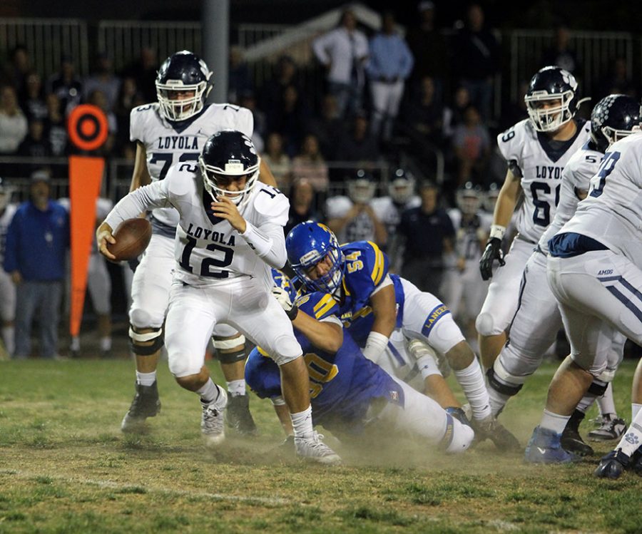 Loyolas QB cant escape from senior Ethan Rodriguez (60) 