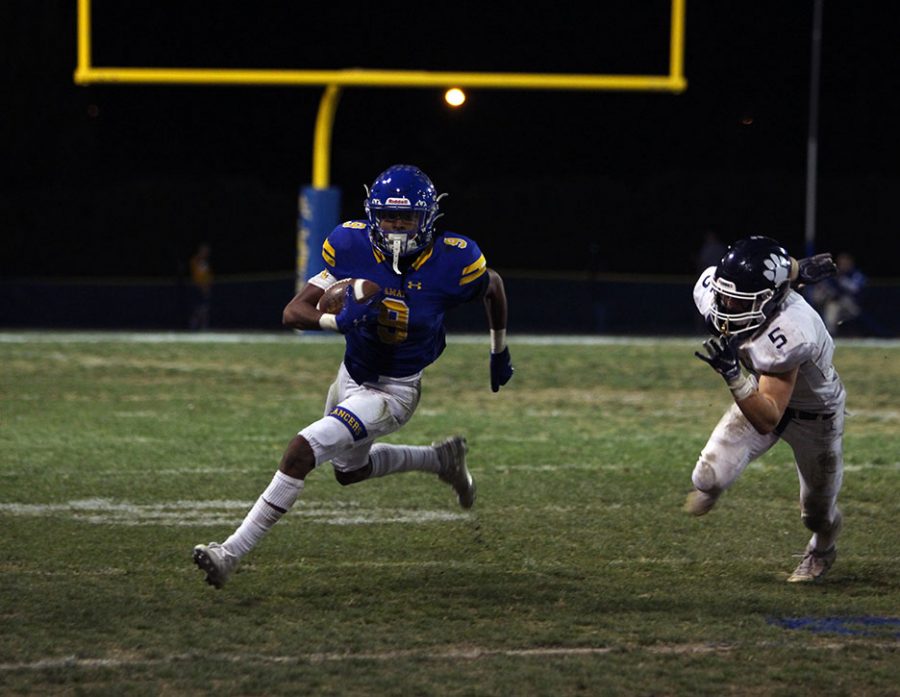 Junior Dyson Mccutcheon (9) sprints away from Loyolas defense 