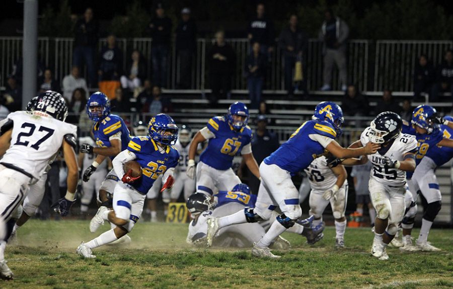 Senior James Henriquez (22) running all the way to the end zone to make a touchdown for the Lancers