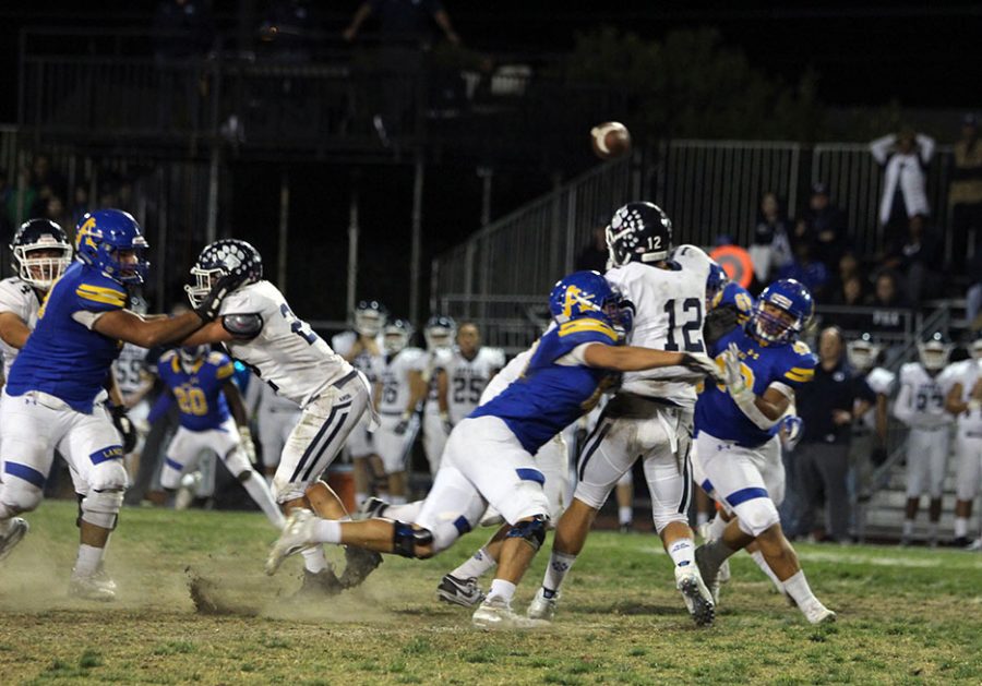 Sophomore Devon Jones (49) shoving his way towards Loyolas QB