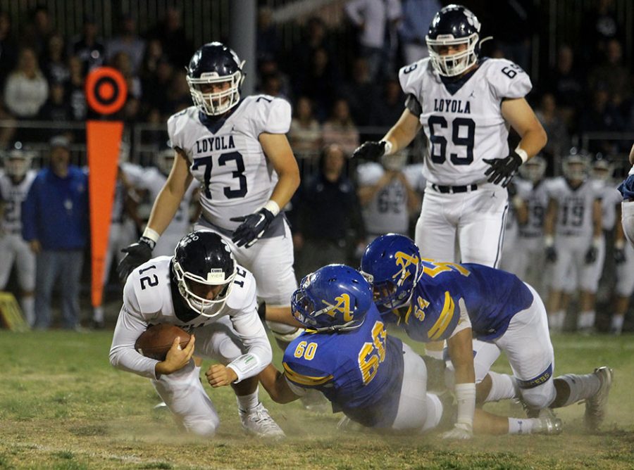 Senior Ethan Rodriguez (60) taking down Loyolas QB