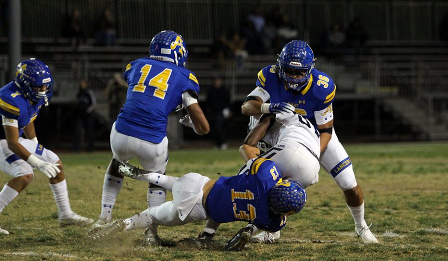 Senior Steven Nava (36) and junior Micah Hidalgo (13) sacks Loyola player