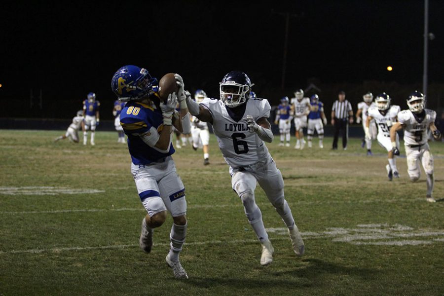 Sophomore Brady Kalau (80) catching a long pass thrown to him