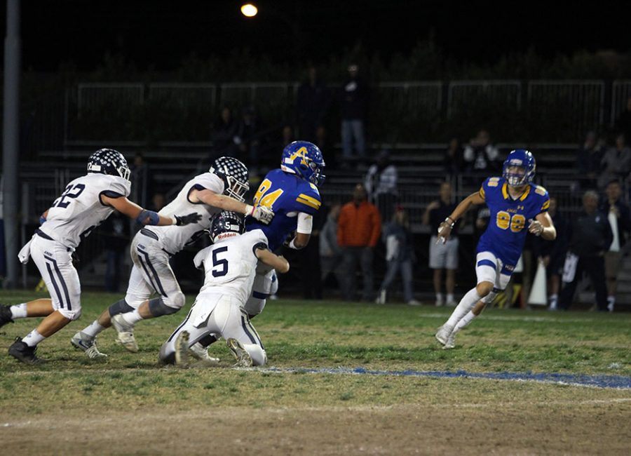 Junior Donavan Clinton (84) trying to escape Loyolas defense