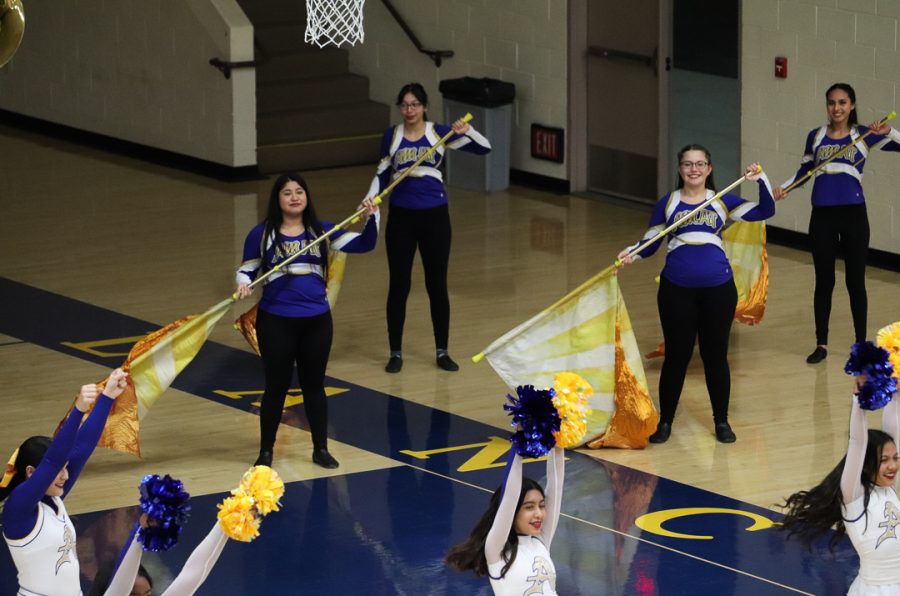 Lancer color guard are showing off what they do. 