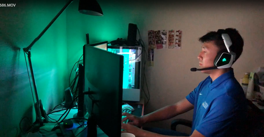 Senior team captain Brandon Le practices League of Legends at home.