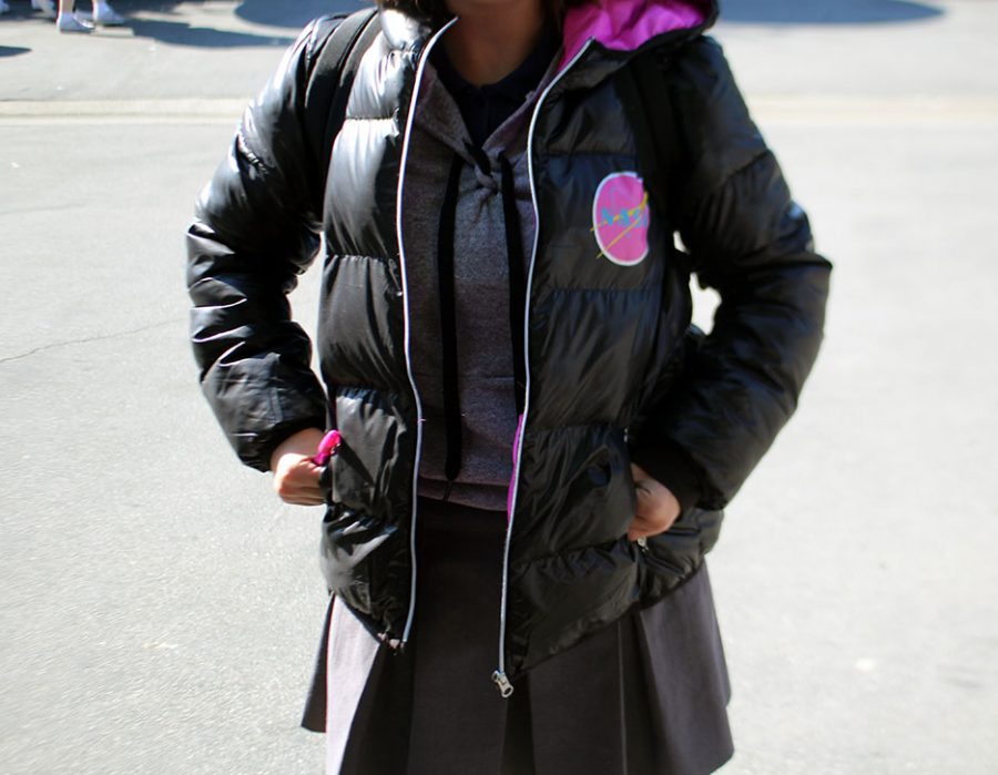 Unidentified female student wears an illegal grey sweater under a black winter coat. 