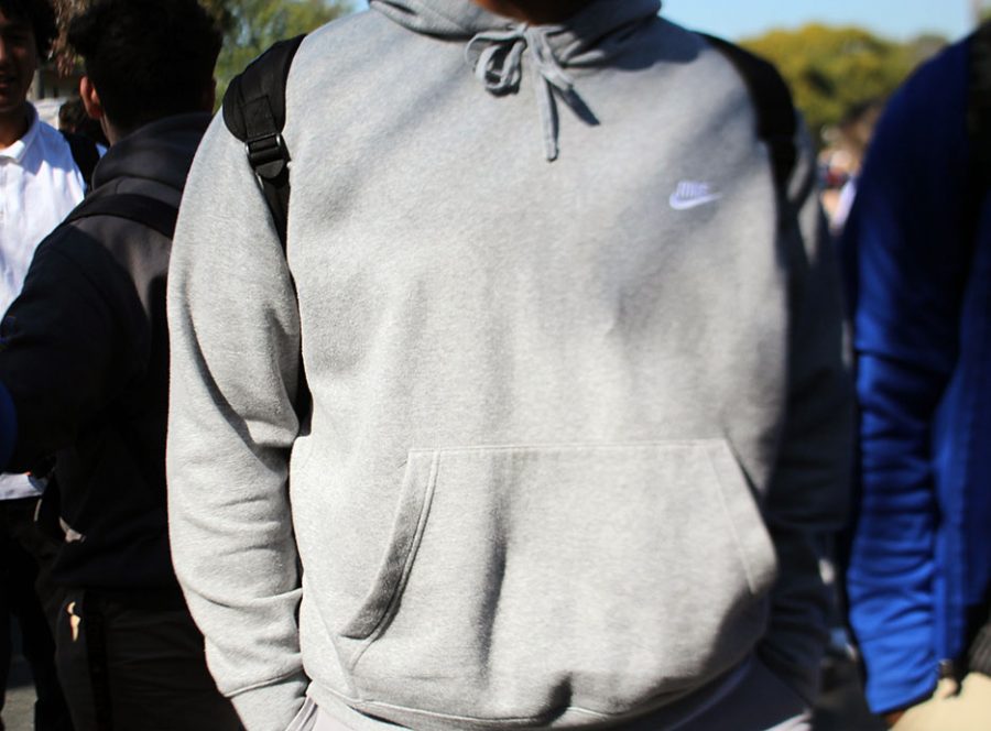 An unidentified student is wearing a grey Nike sweater, violating school policy. 
