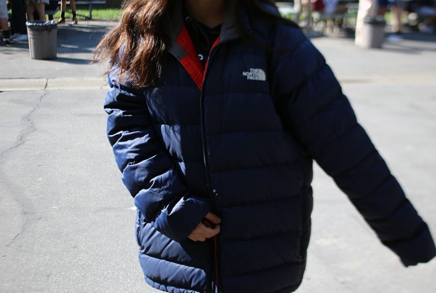 An unidentified student is wearing a puffed up winter jacket, violating school policy. 