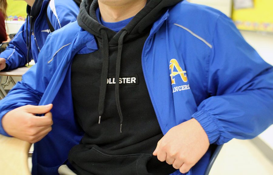 An unidentified would be in Amat dress code if their sweater had no logo. 
