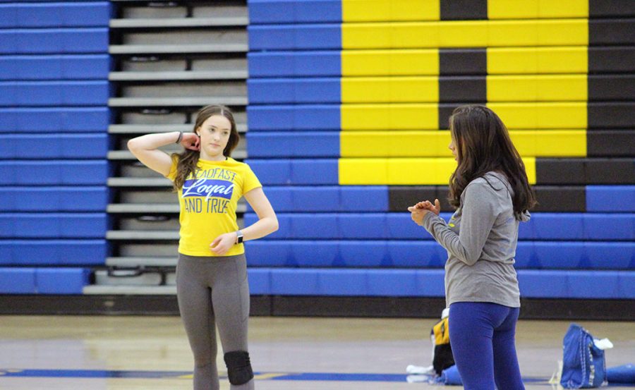 Junior Hailey Gaul talks to pep squad head coach Sabrina Arthun.